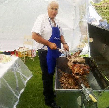 Our chef carving lamb off the spit at a marquee wedding function