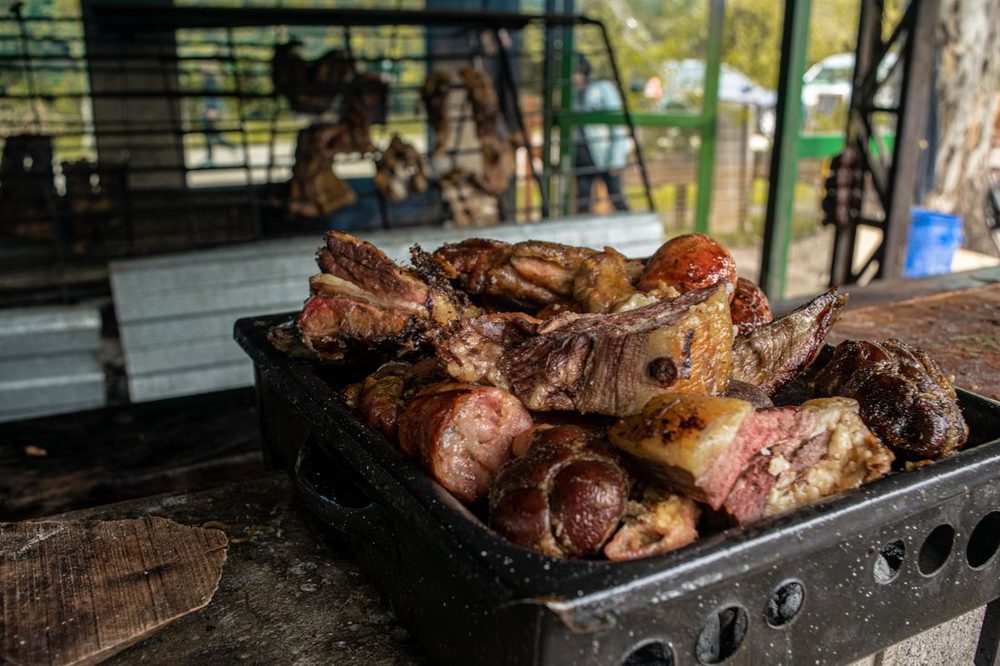 Menu 3 Budget Spit Braai Special &mdash; chops and boerewors grilling on the open braai