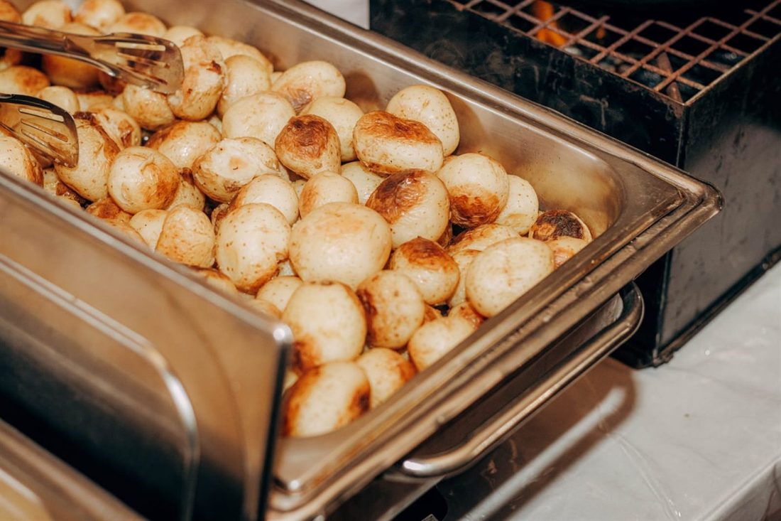 Roast baby potatoes in the chafing dish, straight off the coals