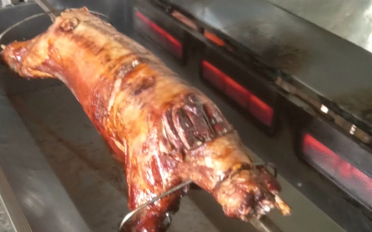 2026 Seasonal Special &mdash; a whole lamb on the spit under the burners
