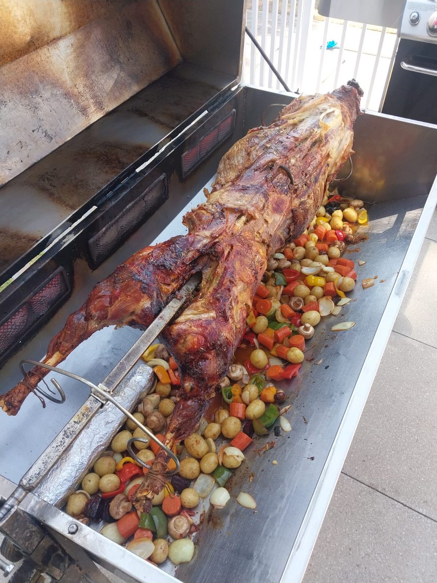Spit braai catering in Gauteng — lamb on the spit with roast vegetables below