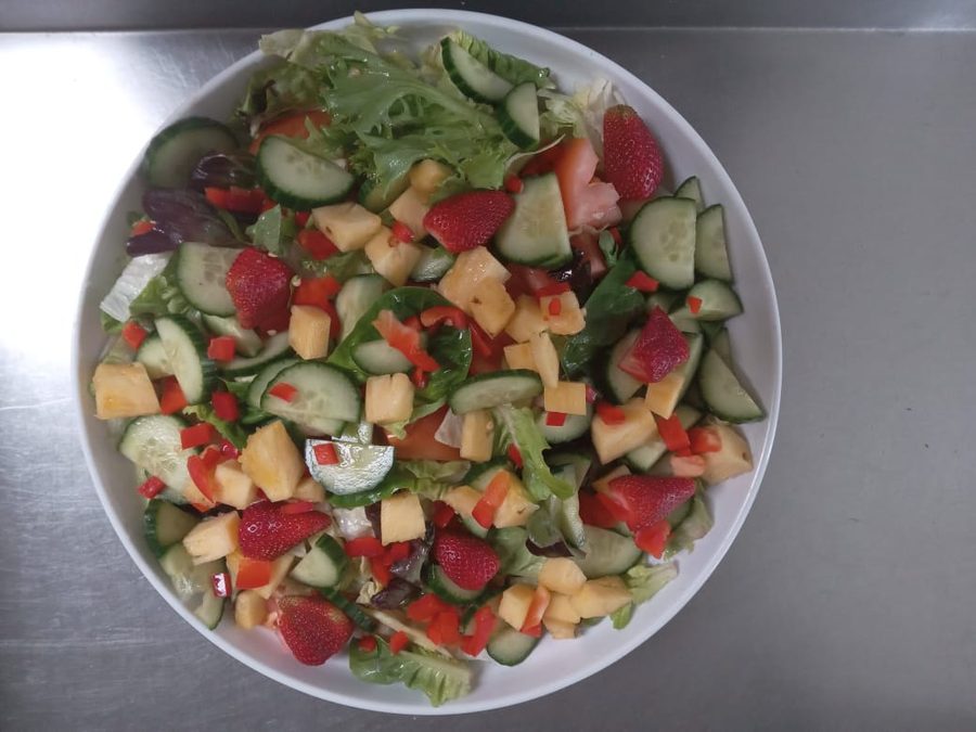 Greek salad prepared fresh on site for a catered function