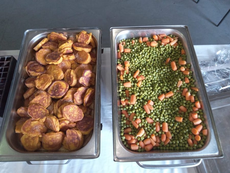 Chicken portions and rolls on the charcoal braai at an outdoor function